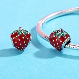 Macro shot of S925 silver red strawberry beads with green zircons on a snake chain