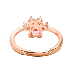 Close-up of rose gold cat paw ring with pink heart-shaped crystal and adjustable band