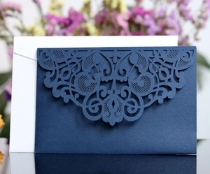 Detail of laser-cut floral pattern on navy blue pearlescent wedding invitation envelope