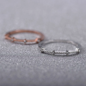 Detail of twisted rope band rings featuring small sparkling cubic zirconia accents