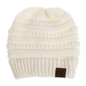 Detail of cream knit beanie featuring thick texture and a brown C.C leather patch