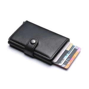 Detail of automatic pop-up aluminum card holder with black lychee pattern leather and snap