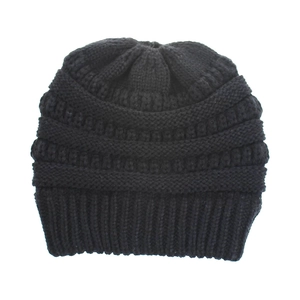 Close-up of thick ribbed knit texture on a solid black winter beanie with wide folded cuff