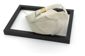 Detail of beige cotton baseball cap with adjustable antique bronze metal buckle closure