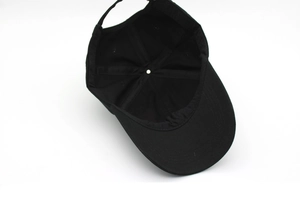 Close-up of the internal structure and stitching of a black cotton baseball cap