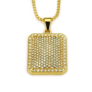 Detail of hip hop dog tag pendant with rows of sparkling crystals on a golden box chain