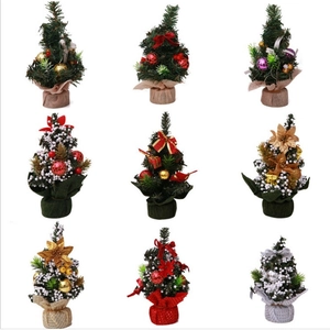 Mini Christmas trees collection with burlap bases, ornaments and snow effect on white background