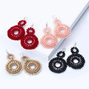 Bohemian style double hoop seed bead earrings in four colors on minimalist white stands