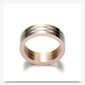 Detailed view of the interlocking gold, white, and rose gold stainless steel bands on the ring