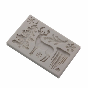 Christmas silicone mold featuring reindeer, snowflake, and tree shapes for DIY cake baking