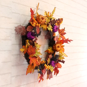 Halloween pumpkin and maple leaf wreath with orange and purple glitter accents for autumn decor