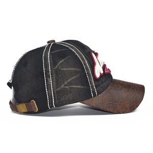 Vintage baseball cap with black washed fabric, brown leather brim and 3D M embroidery