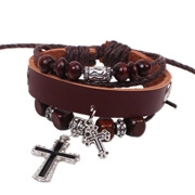 Detail of layered brown braided leather bracelet with silver cross pendants and wood beads