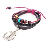 Detailed shot of multilayer leather bracelet with wooden beads and a metal anchor charm