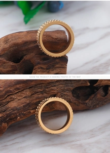 Detailed view of gold plated ring with Clou de Paris texture and pavé zircon stones