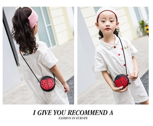Detail of red ladybug crossbody bag with black polka dots and antenna for toddler girls