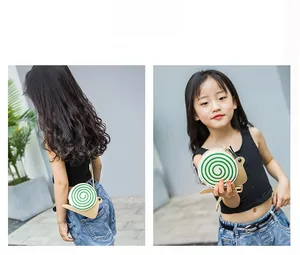 Detail view of khaki snail-shaped kids crossbody bag with green spiral and metal chain