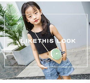 Close-up of cute green snail-shaped crossbody bag with gold chain strap for kids