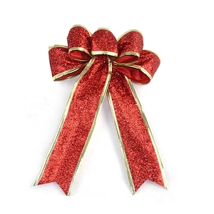 Close-up of red glitter Christmas bow with gold wire edges for holiday decoration