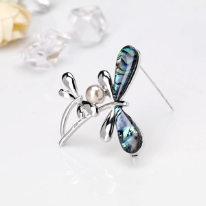 Elegant dragonfly brooch in silver metal with colorful abalone shell wings and pearl