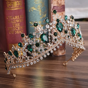 Exquisite gold tiara with sparkling rhinestones and drop-shaped emerald green gemstones