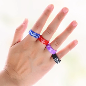 Close-up of flexible silicone sports rings with engraved motivational text for active wear