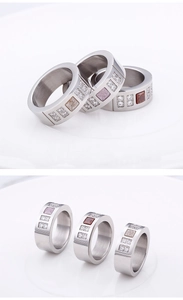 Detail of titanium steel rings with brown and purple square stones and zircon accents