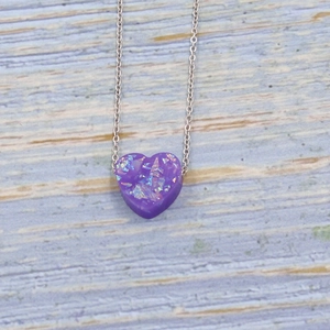 Detailed view of a purple opal heart pendant on a delicate silver necklace chain