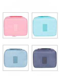 Travel toiletry bags in pink, blue, and grey with waterproof fabric and travel labels