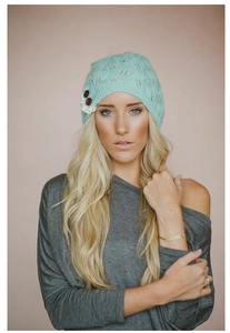 Mint green knitted beanie with leaf pattern and decorative lace buttons for women