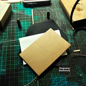 Macro detail of retro kraft paper envelopes with colorful braided rope strings for DIY card storage