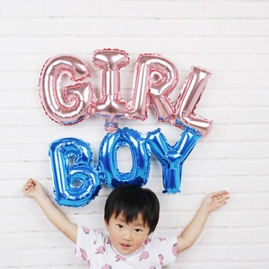 Blue BOY letter foil balloon displayed on a white wall for kids birthday decoration