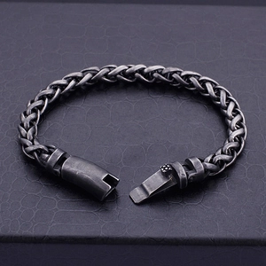 Vintage braided titanium steel link chain bracelet for men on black leather background