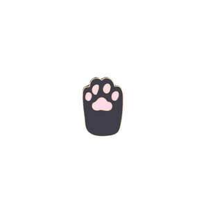 Detail of a cat paw enamel pin with black base, pink pads, and gold metal plating