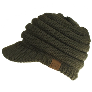 Detailed texture of olive green knitted beanie with visor and leather C.C brand tag