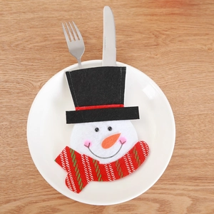 Christmas snowman cutlery holder on white plate with striped scarf and black hat