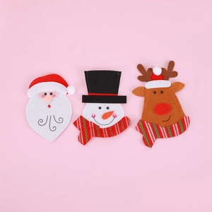 Detailed close-up of felt Santa, Snowman and Reindeer cutlery holders for table decor