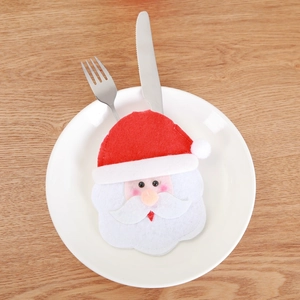 Santa Claus cutlery holder for Christmas table decoration on a white plate