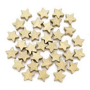 Detailed view of matte gold star-shaped wooden beads with center holes for DIY jewelry