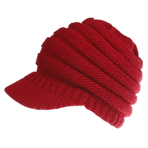 Close-up of red cable knit baseball cap showing the textured rib pattern and short brim