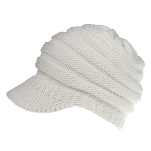 Detailed close-up of thick white knitted baseball cap with textured ribbed design layers