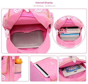 Detail view of pink school backpack interior compartments showing books and laptop storage