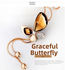 Detail of rose gold butterfly pendant with amber gemstones and sparkling rhinestones