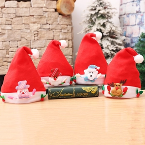 Plush Christmas hats with snowman and reindeer characters on a cozy wooden table