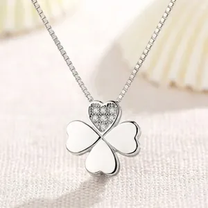 Close-up of S925 silver heart shaped clover necklace with sparkling stone detail