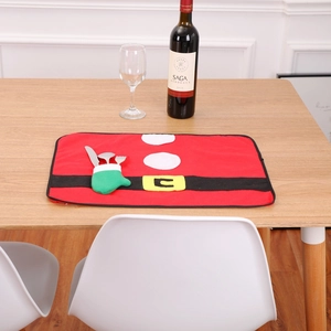 Close-up of Santa suit Christmas placemat with built-in cutlery holder on wooden table