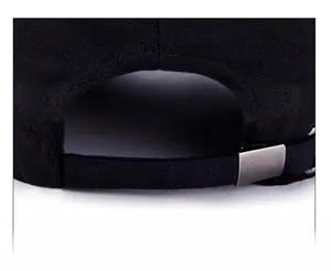 Close-up of adjustable strap with metal buckle on a black canvas baseball cap