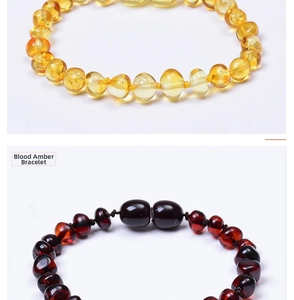 Detail of Baltic amber bracelets in bright yellow and deep red blood amber with screw clasps