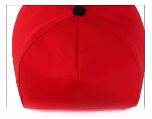 Detailed top view of red cotton baseball cap showing reinforced seams and black button