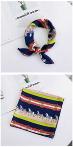 Close-up of silk square scarf featuring equestrian patterns and horse print details